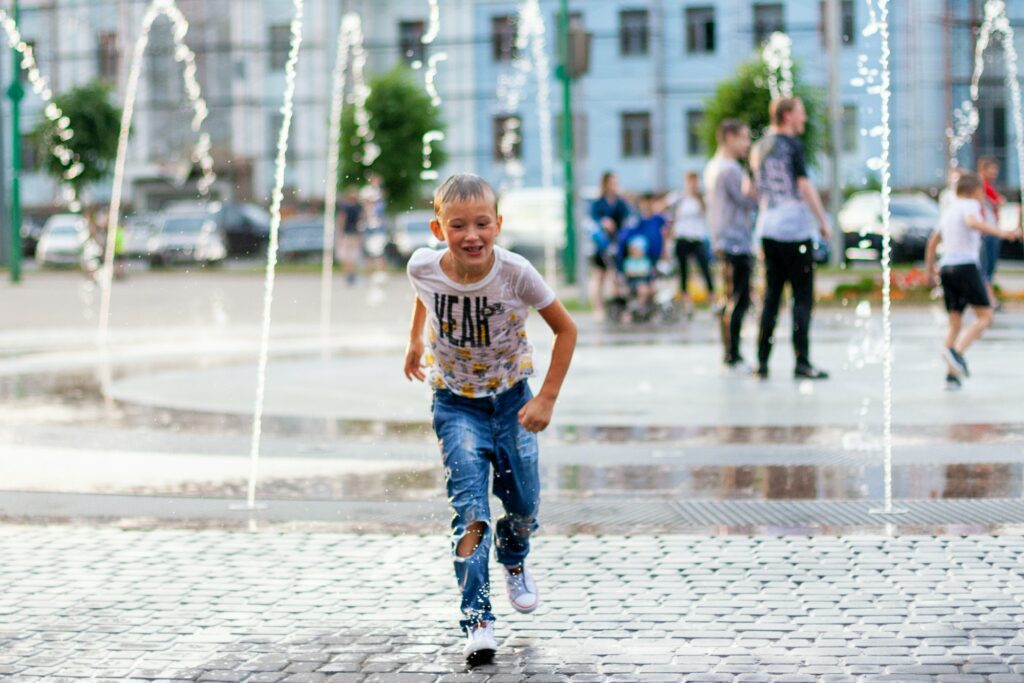 happy boy fountain street . Emotions. Splash