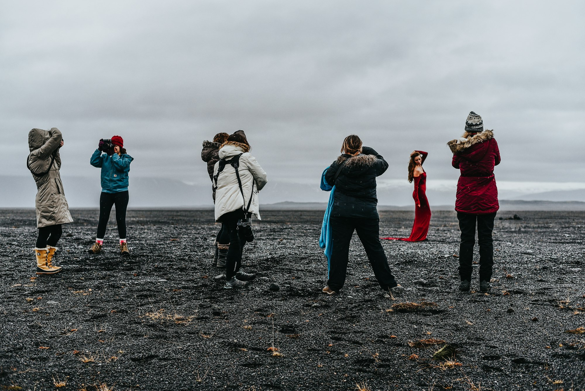 A group of photographers photographing a model in Iceland